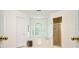 Bathroom features a bathtub under a window and a glass-doored shower at 120 Stanmore Ct, Roswell, GA 30075