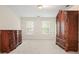 Bedroom showcasing carpeted flooring and neutral walls, accentuated by natural light from the windows at 120 Stanmore Ct, Roswell, GA 30075