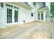 Wooden deck with white railing and a view of the home's white exterior and French doors at 120 Stanmore Ct, Roswell, GA 30075