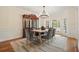 Elegant dining room with a wooden table, velvet chairs, and a classic china cabinet at 120 Stanmore Ct, Roswell, GA 30075