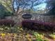 Landscaped entrance with a stone wall and beautiful flowers, creating a welcoming atmosphere at 120 Stanmore Ct, Roswell, GA 30075
