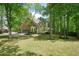 Exterior of a home with a brick facade, attached garage, and a well-maintained lawn at 120 Stanmore Ct, Roswell, GA 30075