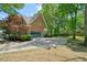 Home exterior featuring a brick facade, gray garage doors, and meticulously manicured lawn at 120 Stanmore Ct, Roswell, GA 30075