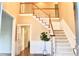 Inviting foyer featuring a staircase with wooden banister, and an entryway leading to other rooms at 120 Stanmore Ct, Roswell, GA 30075