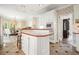 Well-lit kitchen with white cabinets, an island with seating, and updated appliances at 120 Stanmore Ct, Roswell, GA 30075