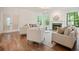 Bright living room with hardwood floors, fireplace, recessed lights and elegant furniture at 120 Stanmore Ct, Roswell, GA 30075