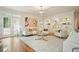 Sophisticated living room featuring built-in shelves, modern furniture and a beautiful chandelier at 120 Stanmore Ct, Roswell, GA 30075