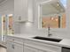 Modern kitchen with quartz countertops, herringbone backsplash, and stainless steel faucet at 122 Parkview Dr, Dallas, GA 30157