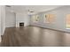 Bright living room with a cozy fireplace, hardwood floors, and large windows with a view at 122 Parkview Dr, Dallas, GA 30157