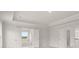 Primary bedroom with tray ceilings, white trim and doorway to ensuite bathroom at 122 Parkview Dr, Dallas, GA 30157