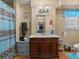 Functional bathroom featuring a vanity, sink, mirror, and patterned shower curtain at 1480 Niskey Lake Sw Rd, Atlanta, GA 30331