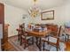 Formal dining room featuring a chandelier, a wooden table, and a decorative mirror at 1480 Niskey Lake Sw Rd, Atlanta, GA 30331