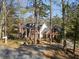 Charming two-story brick home with a columned front porch, surrounded by mature trees at 1480 Niskey Lake Sw Rd, Atlanta, GA 30331