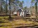 Side view of the house with a garage and plenty of backyard trees at 1480 Niskey Lake Sw Rd, Atlanta, GA 30331