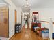 Hallway featuring wood floors, neutral walls, and a chandelier plus personal items and a mirror at 1480 Niskey Lake Sw Rd, Atlanta, GA 30331