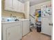 Laundry room equipped with washer, dryer, refrigerator, and storage shelves at 1480 Niskey Lake Sw Rd, Atlanta, GA 30331