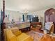 Main bedroom featuring a four-poster bed, wooden floors, and ample closet space at 1480 Niskey Lake Sw Rd, Atlanta, GA 30331