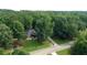 Aerial view of a brick home with lush, mature trees and landscaping at 235 Huiet Dr, Mcdonough, GA 30252