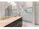 Elegant bathroom with double sink vanity and glass enclosed shower at 235 Huiet Dr, Mcdonough, GA 30252
