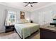 Cozy bedroom featuring soft natural light, ceiling fan, neutral walls and carpet, with traditional furnishings at 235 Huiet Dr, Mcdonough, GA 30252