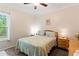 Charming bedroom with natural light, ceiling fan, and comfortable queen bed and side tables at 235 Huiet Dr, Mcdonough, GA 30252
