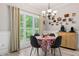 Cozy dining area with chandelier and natural light from large window at 235 Huiet Dr, Mcdonough, GA 30252