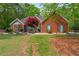 Charming brick home featuring a manicured lawn, landscaped garden, and a classic architectural design at 235 Huiet Dr, Mcdonough, GA 30252