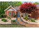 Beautifully landscaped front yard with manicured shrubbery and walkway to front door at 235 Huiet Dr, Mcdonough, GA 30252