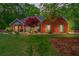 Beautiful brick home featuring a well-manicured lawn, colorful landscaping, and inviting curb appeal at 235 Huiet Dr, Mcdonough, GA 30252