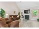 Cozy living room featuring tile floors, fireplace, and access to outdoor views at 235 Huiet Dr, Mcdonough, GA 30252