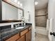 Bathroom featuring granite vanity and shower-tub combo at 239 Devonwood Dr, Atlanta, GA 30328