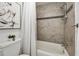 Bathroom featuring a shower and tub with neutral tile, a black accent stripe, and decor at 239 Devonwood Dr, Atlanta, GA 30328