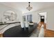 Well-lit dining room featuring hardwood floors, a modern table, and a view to the patio through a window at 239 Devonwood Dr, Atlanta, GA 30328