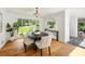 Elegant dining room with hardwood floors, a modern table, a large window, and stylish decor at 239 Devonwood Dr, Atlanta, GA 30328