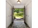 Light-filled foyer with slate flooring, double closets, and an open view to the lush greenery outside at 239 Devonwood Dr, Atlanta, GA 30328