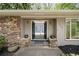 Close up of a stone accented house with black double doors and fresh landscaping at 239 Devonwood Dr, Atlanta, GA 30328