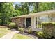 Inviting front entrance with stone details, fresh landscaping, and a modern double door for a sophisticated welcome at 239 Devonwood Dr, Atlanta, GA 30328