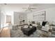 Inviting living room featuring hardwood floors, large windows, neutral decor, and a stylish coffee table at 239 Devonwood Dr, Atlanta, GA 30328