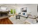 Living room features fireplace, hardwood floors, neutral furniture, and access to the backyard at 239 Devonwood Dr, Atlanta, GA 30328