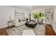 Bright living room with hardwood floors, a large window, built-in shelves, and stylish neutral decor at 239 Devonwood Dr, Atlanta, GA 30328