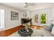Bright living room with a stone fireplace, hardwood floors, and backyard views at 239 Devonwood Dr, Atlanta, GA 30328