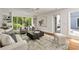 Cozy living room featuring hardwood floors, a large window, built-in shelving, and comfortable seating arrangements at 239 Devonwood Dr, Atlanta, GA 30328