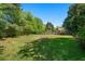 Large grassy backyard with mature trees and a wooden fence at 2921 Huntcliff Dr, Marietta, GA 30066