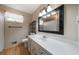 Bathroom with a white vanity, framed mirror, and wood look flooring at 2921 Huntcliff Dr, Marietta, GA 30066