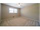 Cozy bedroom with a window, neutral carpeted floors, and light beige walls creating a serene atmosphere at 2921 Huntcliff Dr, Marietta, GA 30066