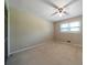 Light-filled bedroom with neutral walls, plush carpeting, and a ceiling fan, creating a calm environment at 2921 Huntcliff Dr, Marietta, GA 30066