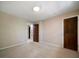 Neutral bedroom featuring beige walls, carpeted floors, wooden doors, and a centered ceiling light at 2921 Huntcliff Dr, Marietta, GA 30066