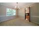 Light-filled dining room with neutral walls, carpet and a view to the kitchen at 2921 Huntcliff Dr, Marietta, GA 30066