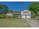 Charming home featuring a well-maintained lawn, mature landscaping, and a two-car garage at 2921 Huntcliff Dr, Marietta, GA 30066