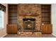Charming fireplace with stone surround and built-in shelves for displaying books and decor at 2921 Huntcliff Dr, Marietta, GA 30066